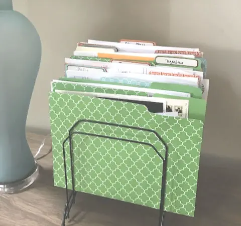 Great tips to organize paper clutter. Pretty file folders and a fire box help to keep the paper work organized.