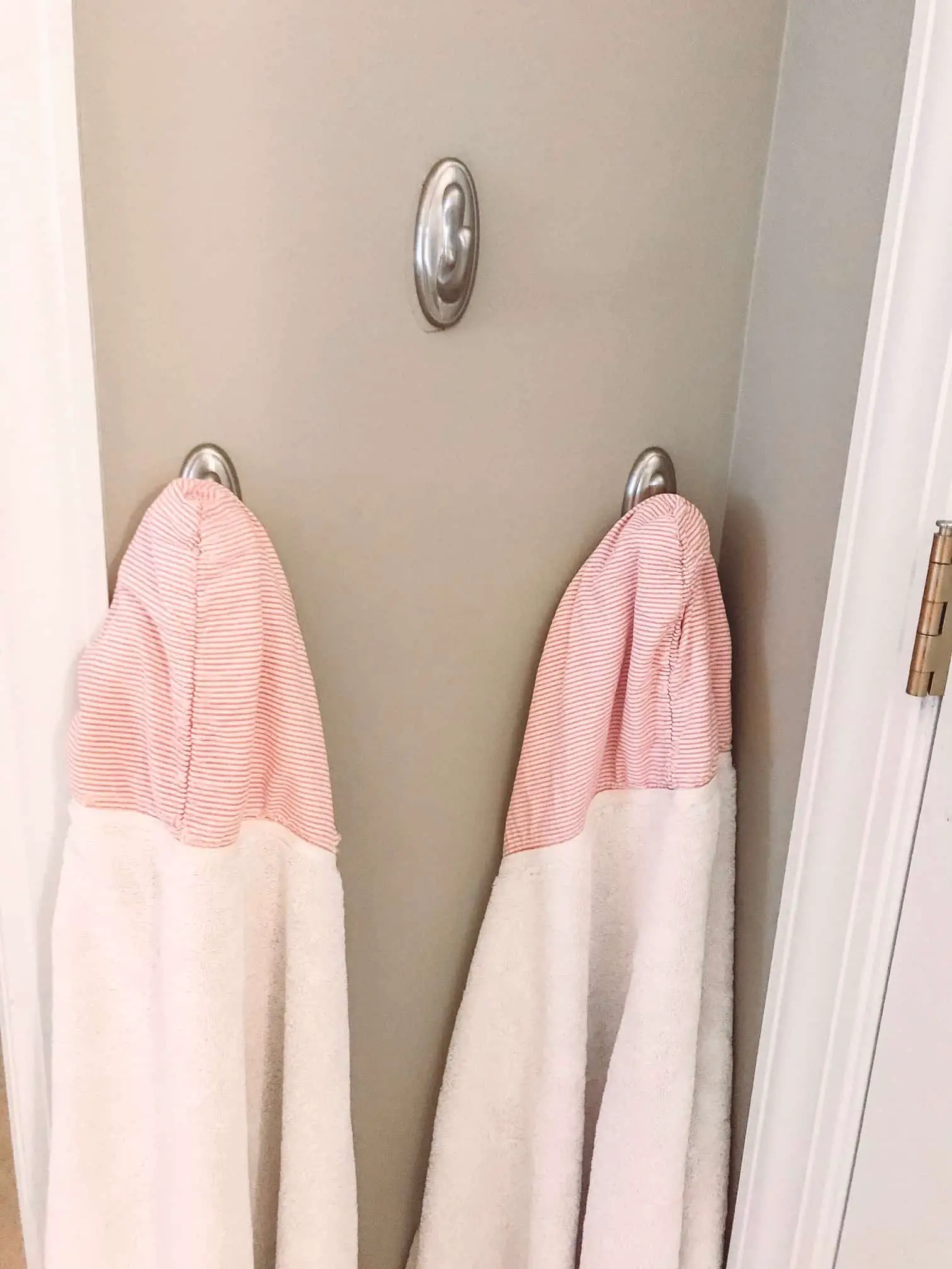 Bathroom Storage Hacks to help make your mornings easier. Hanging extra towel hooks.