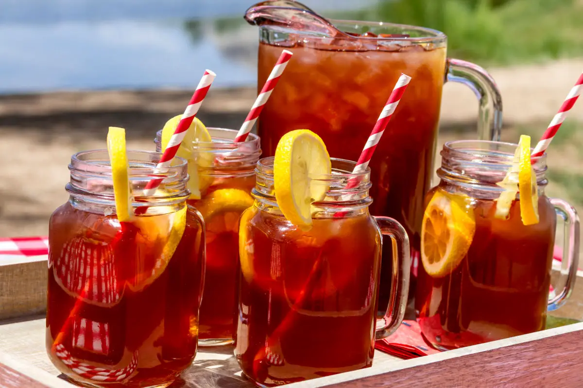 Pitcher and mason jar mugs filled with iced tea - Does Sweet Tea Have Caffeine